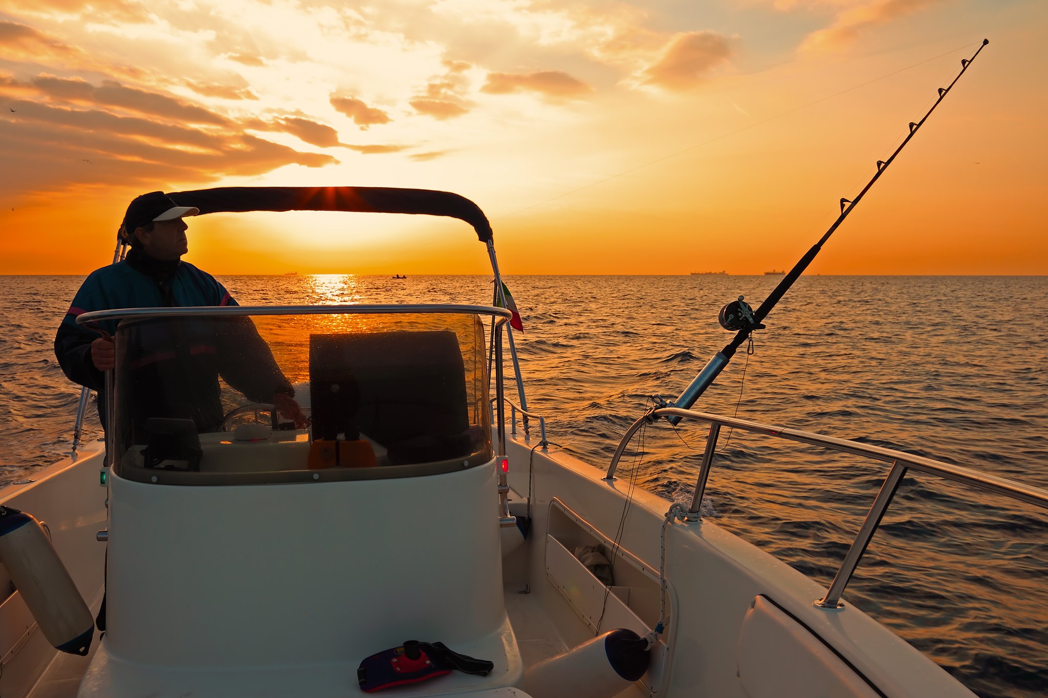 Angler setting out on a fishing boat at sunrise